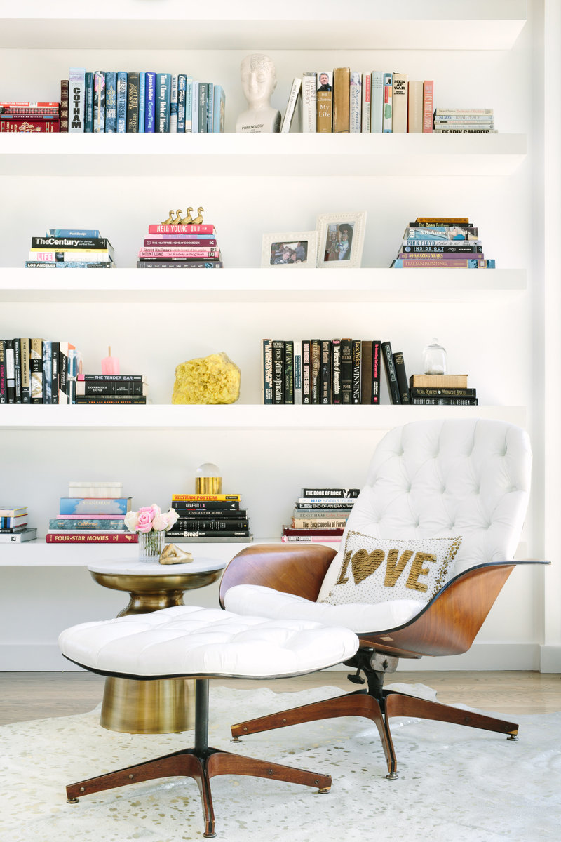 Living room with mid century modern Plycraft Lounge chair and floating bookcase.