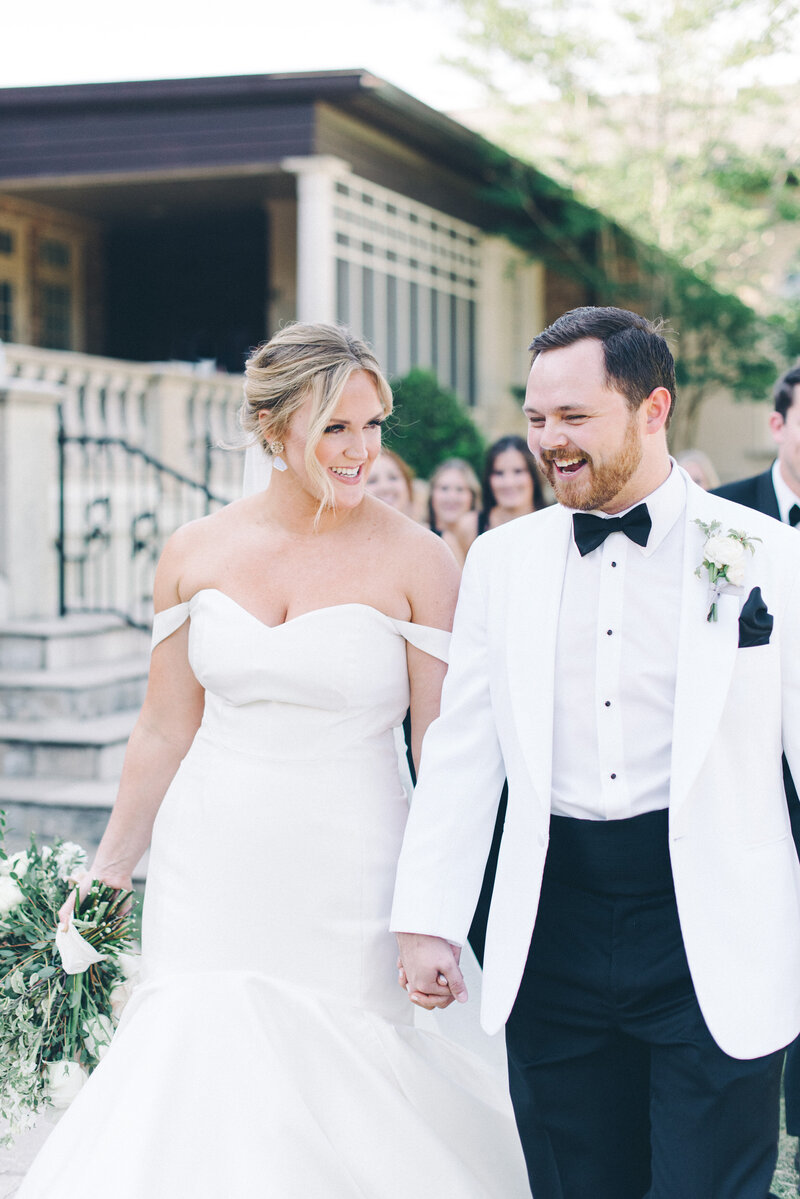 A married couple walking with each other on their wedding day at Fountainview Mansion