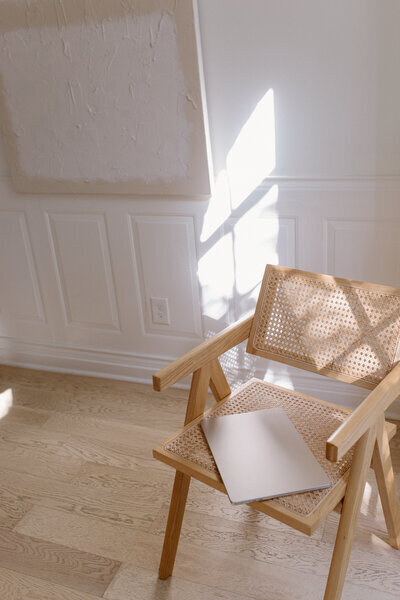 laptop on chair to show showit template customization by Flourish Foundry Designs