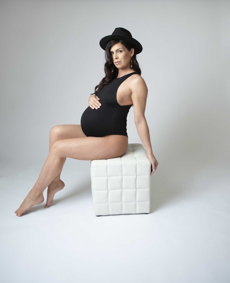 pregnant mom on a cube with a hat