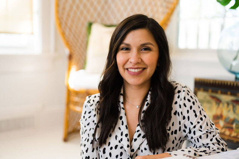 a portrait of Karen, a local real estate agent, smiling and wearing a black and white blouse