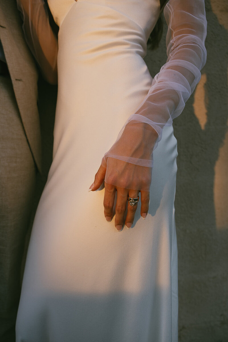 Bride's ring and gown glow in the sunset light in downtown Nashville. 