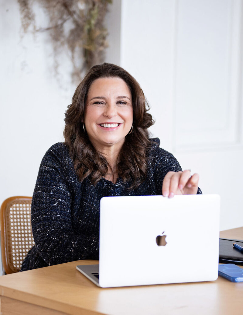 Dr. Chris Limone in conversation with a client on a sofa, engaged in supportive coaching dialogue