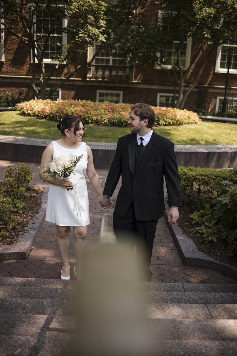 Elopement moment as groom places ring on his beautiful Asian wife.