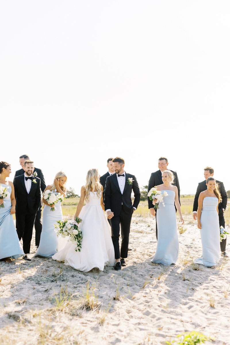 wedding party on the sand for wedding portraits with cape cod wedding photographer in Harwich port, MA