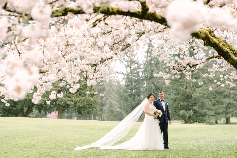 Bride and groom holding hands and walking through bridal party