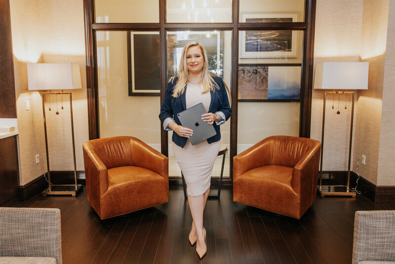 Woman holding a laptop and smiling