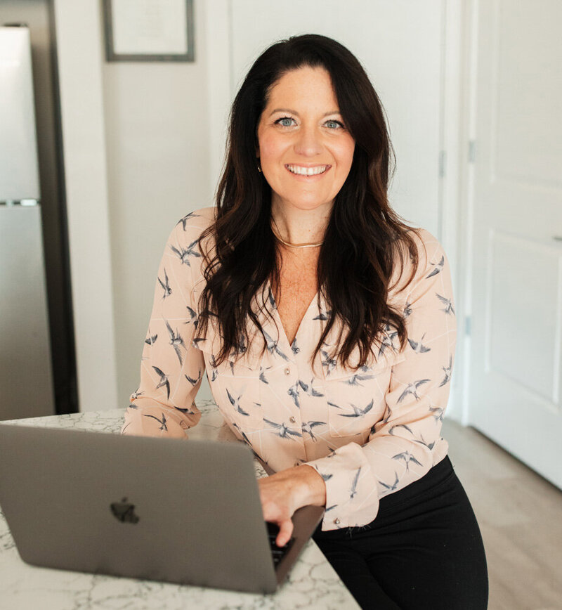 Alison Seponara in a pink shirt with a laptop