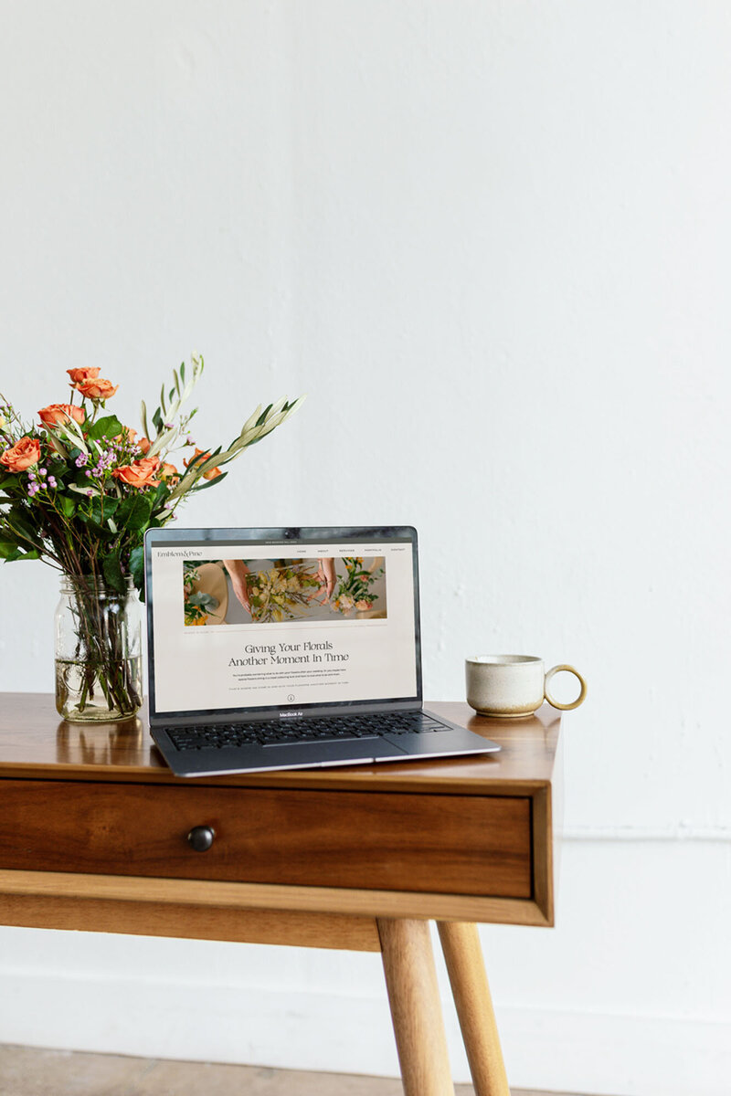 Laptop on a table with coffee showing showit template customization by Palme Design Co