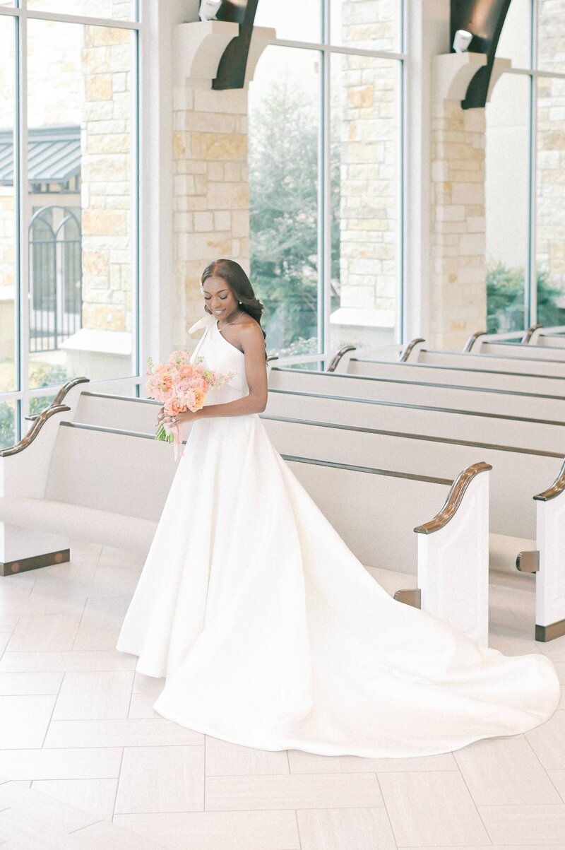 Dallas-Fort Worth Wedding Photographer | DFW Photographer Rae De Lain Weddings Light and Airy | Black Bride holding a pink and orange bouquet at The Bowden