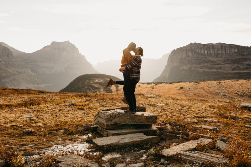 man holding up woman