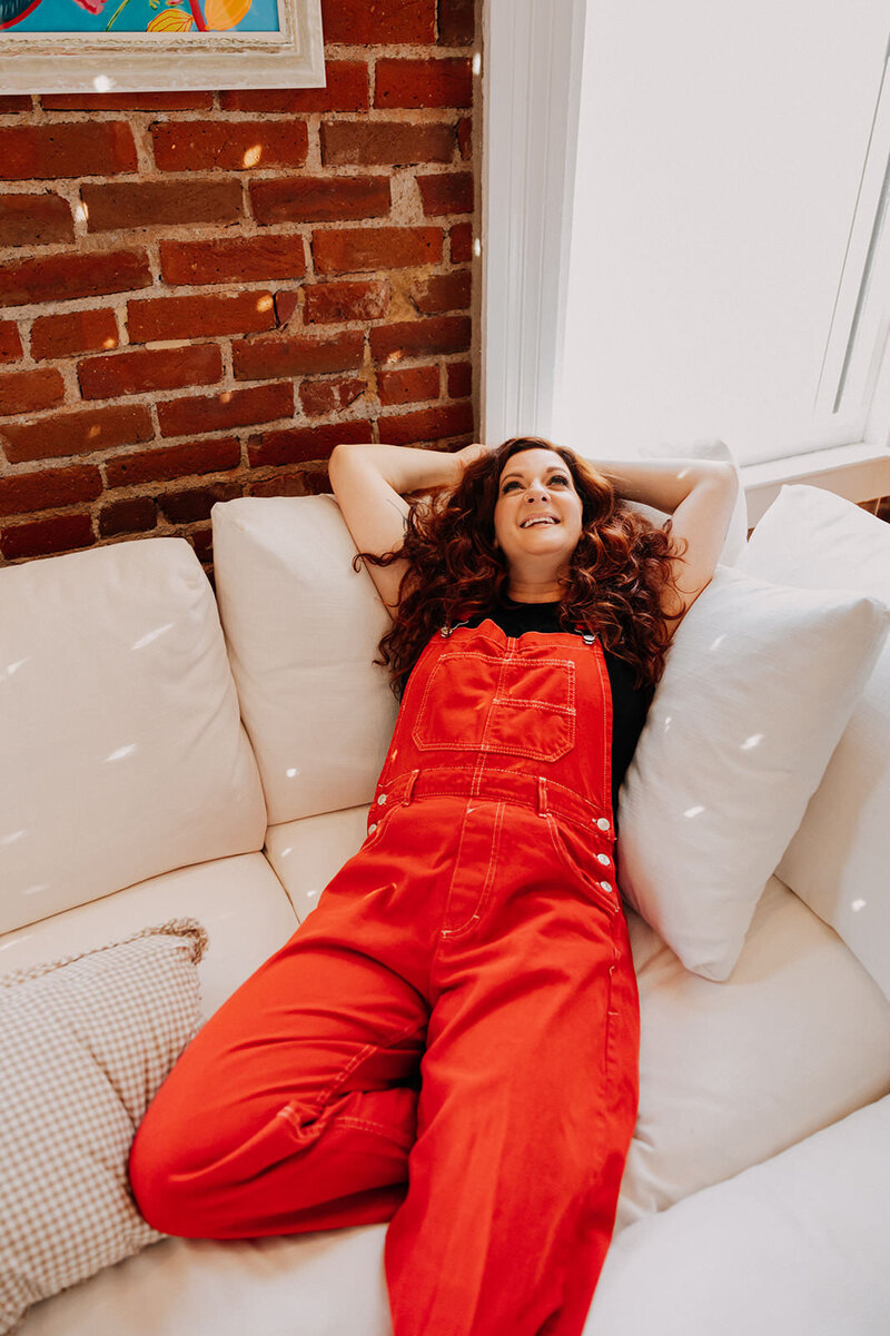 A woman lounging back on a couch.