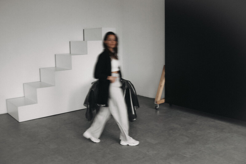 Motion blur photo of brand and web designer kim walking through a photo studio