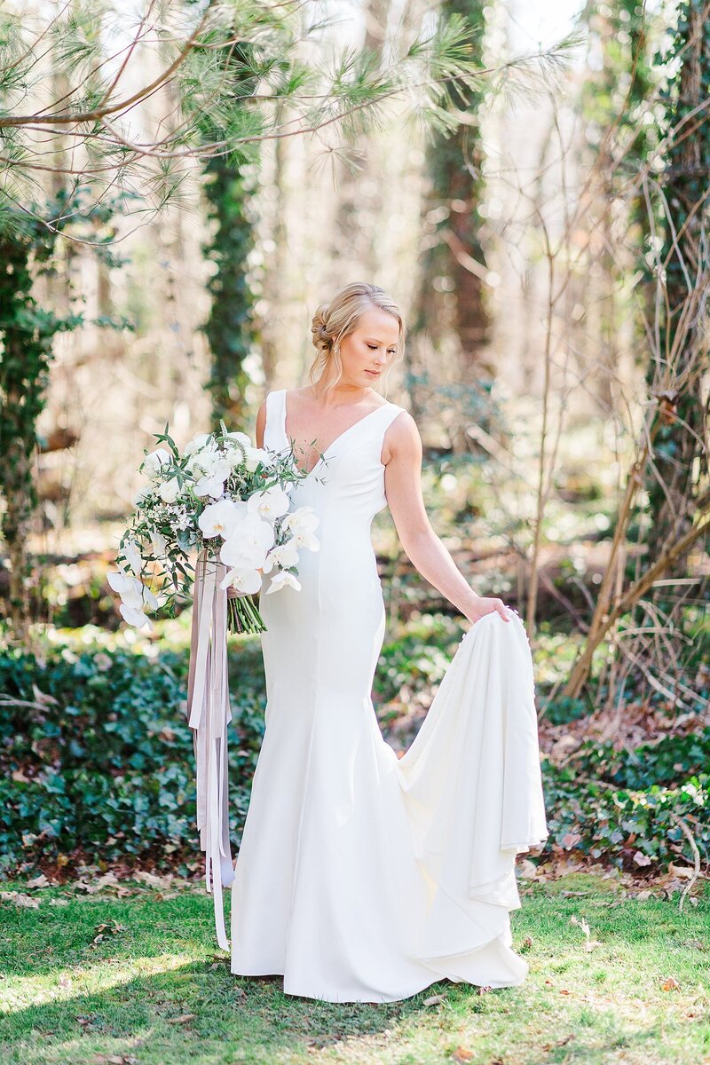 bride holding train by Knoxville Wedding Photographer, Amanda May Photos