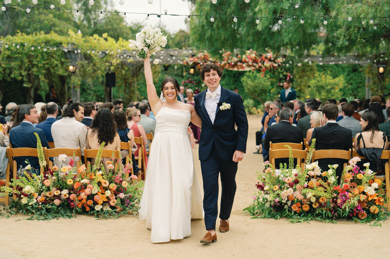 bride and groom celebrate as they exit their ceremony at the santa barbara historic museum wedding