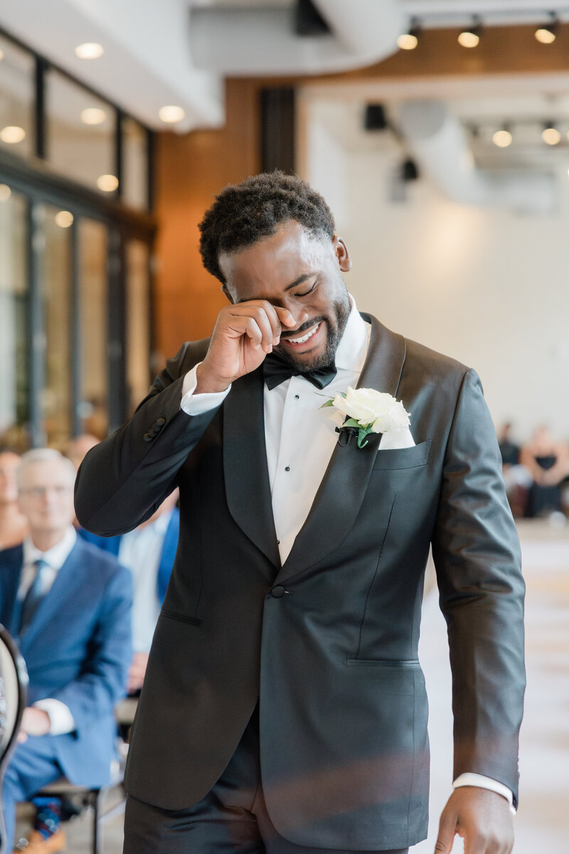 A Groom crying as he walks down the aisle at his wedding at the Ben, autograph collection in west palm beach.