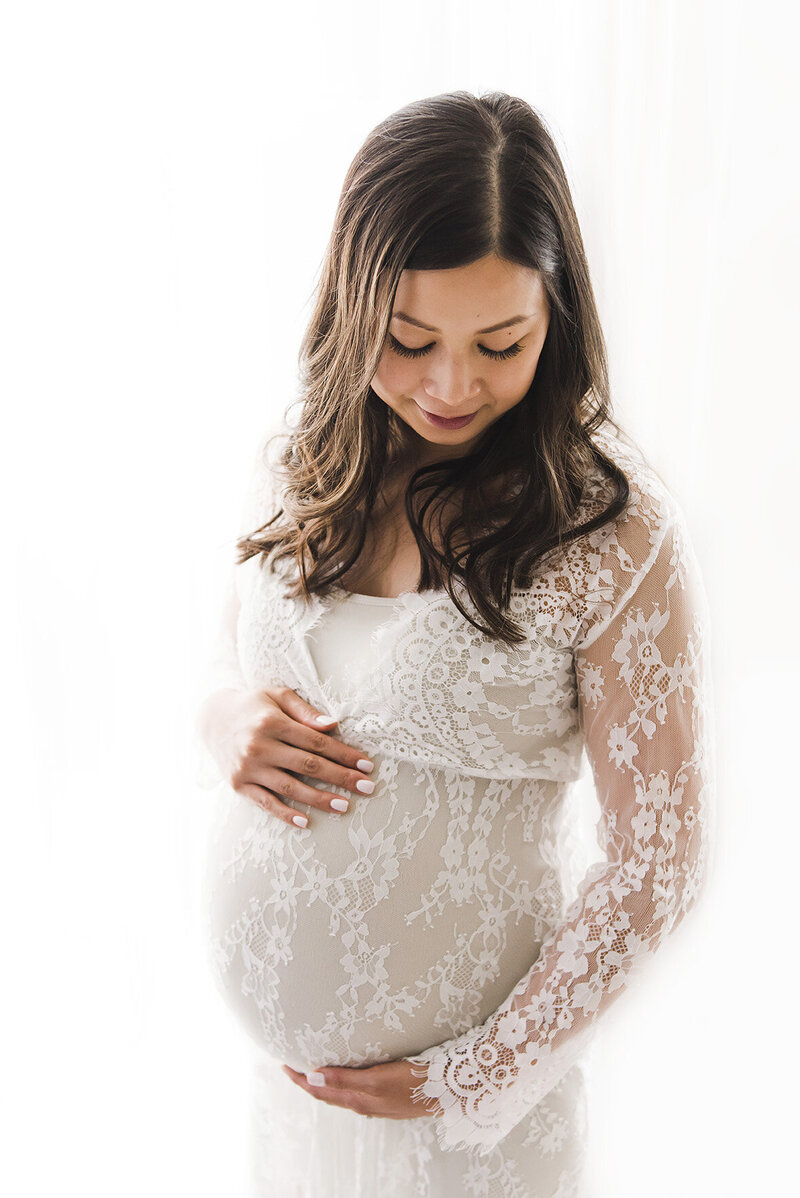 pregnant woman posing for maternity photographer boston ma​