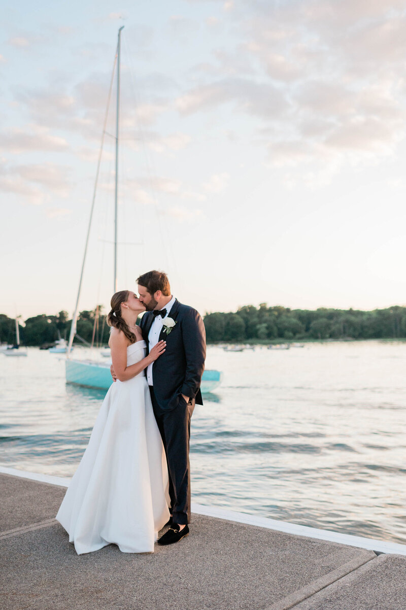Newlyweds kiss in front of a Greenwich Waterfront 