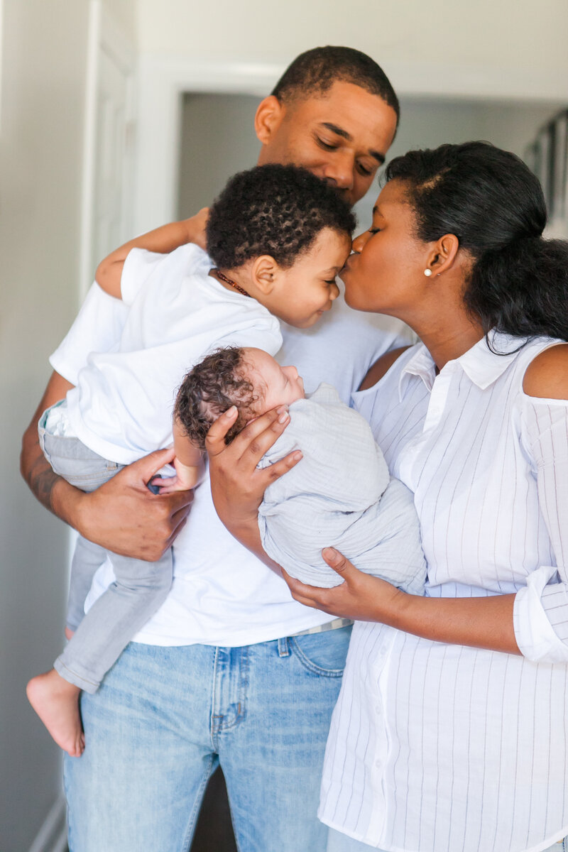 Mom and dad holding their newborn and young son – Columbia SC family photography.