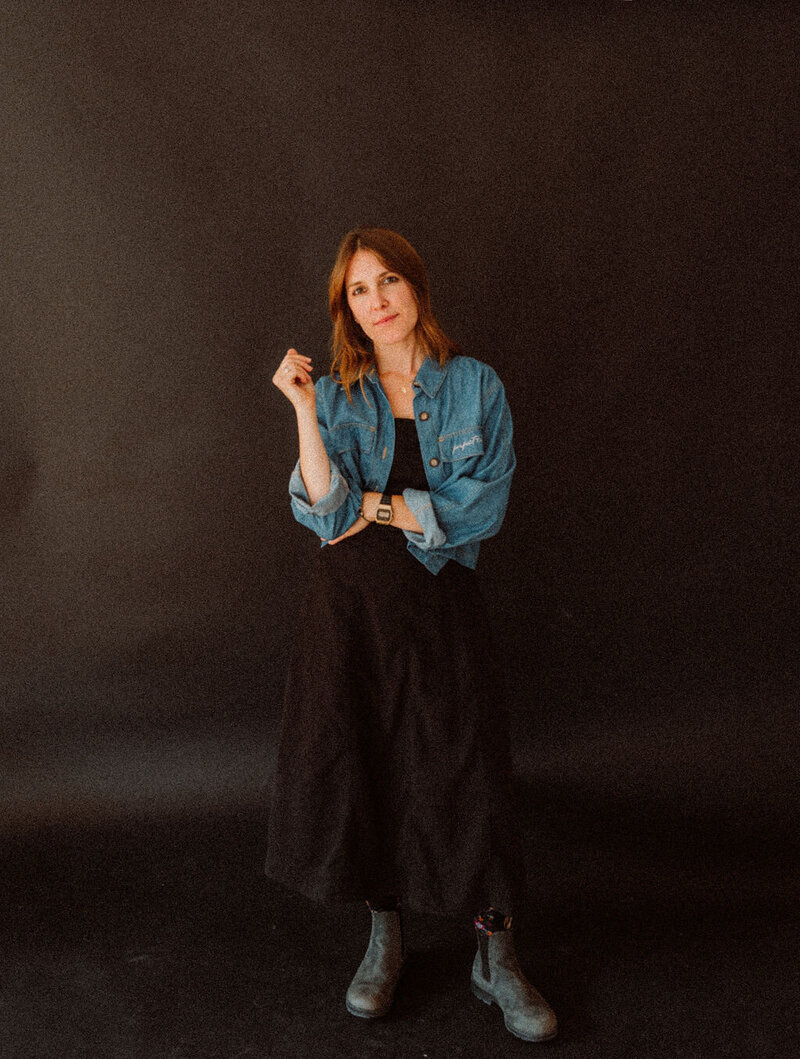 Boise event planner, Alex, looks at the camera with one arm crossed, representing her fierce demeanor. 