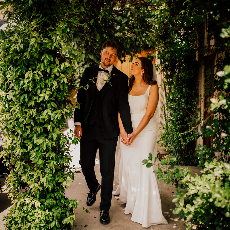 Couple in courtyard greenery