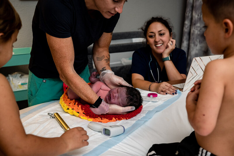 Joani Koenig smiling at new mom at homebirth