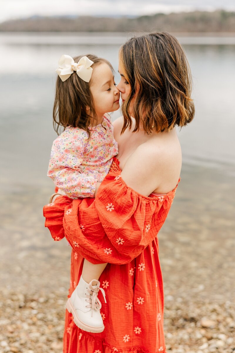 a mom holding her little girl