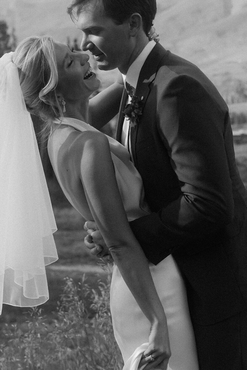 Bride and groom laughing together
