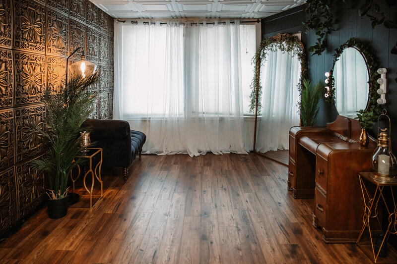 studio shot of a window, floor, gold wall and venaity