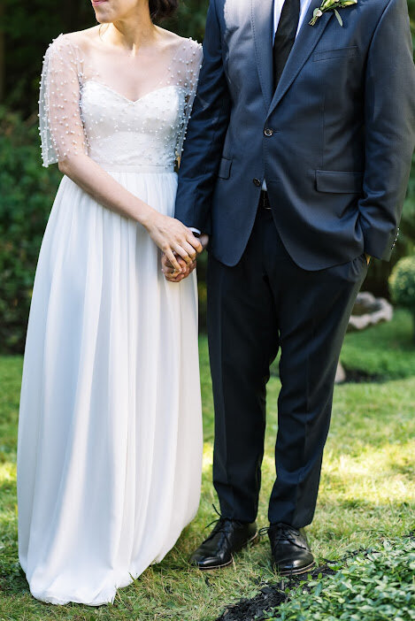 The bride dazzles in a handmade dress by Katrina Tuttle at this intimate backyard wedding in Halifax, Nova Scotia. Captured by Alyssa Joy Photography, the celebration is filled with personal touches and rustic elegance. The charming backyard setting, adorned with delicate floral arrangements and fairy lights, creates a cozy and romantic atmosphere. The bride’s bespoke dress perfectly complements the intimate and heartfelt nature of the event. Keywords: handmade wedding dress, Katrina Tuttle, intimate wedding, backyard wedding, Halifax Nova Scotia wedding, Alyssa Joy Photography, rustic wedding, personalized wedding details.