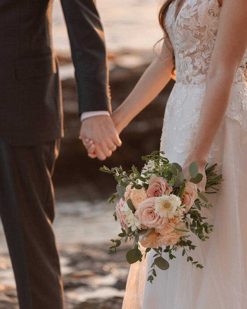 candid Wedding Photos of couple holding hands on beach in Pismo Beach at Dolphin Bay Resort & Spa