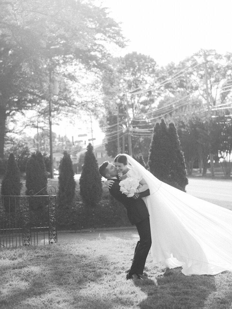 bride & groom snuggle in a light filled green house on a fall day