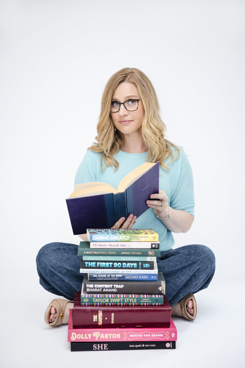 A woman laughs while holding a newspaper that says "better photos lead to more business"