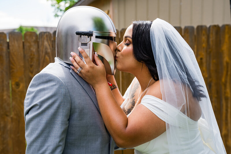 Star Wars–themed micro wedding couple posing together in Colorado Springs, with the groom wearing a Mandalorian-inspired helmet.