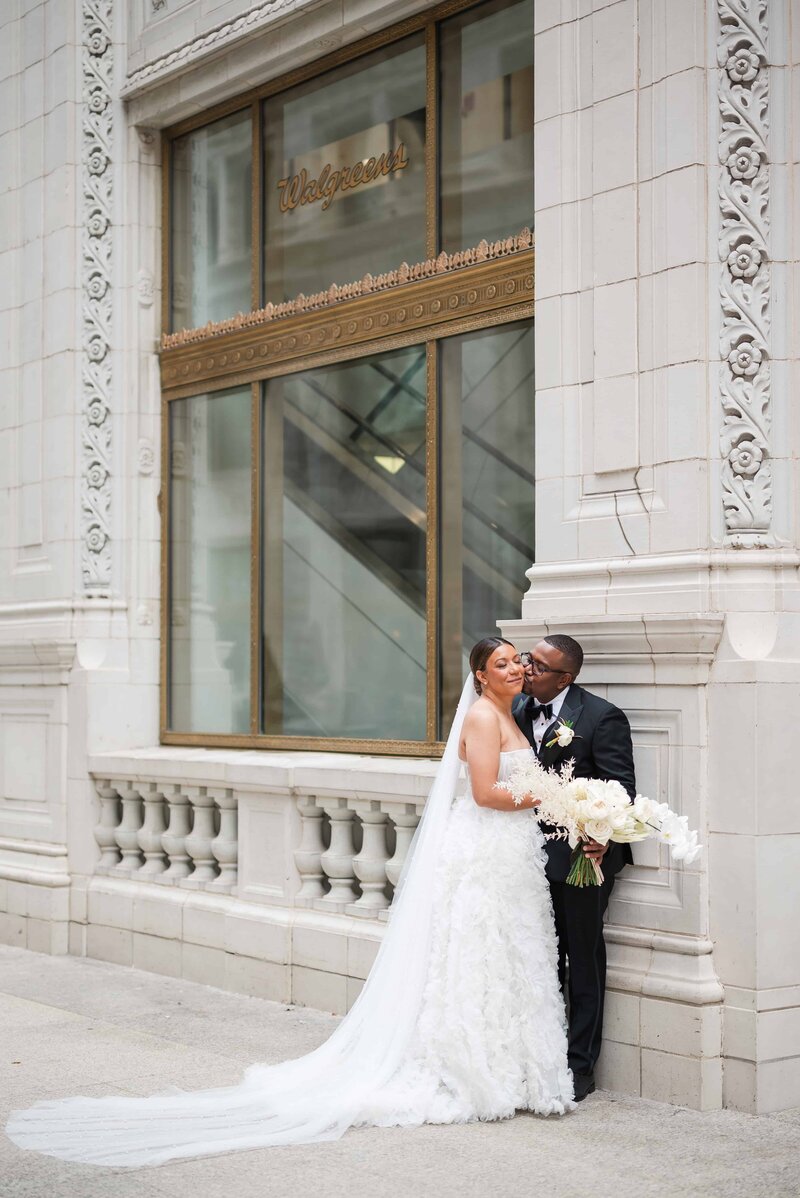 Bride and groom sharing an intimate moment at The Wrigley building in  downtown Chicago.