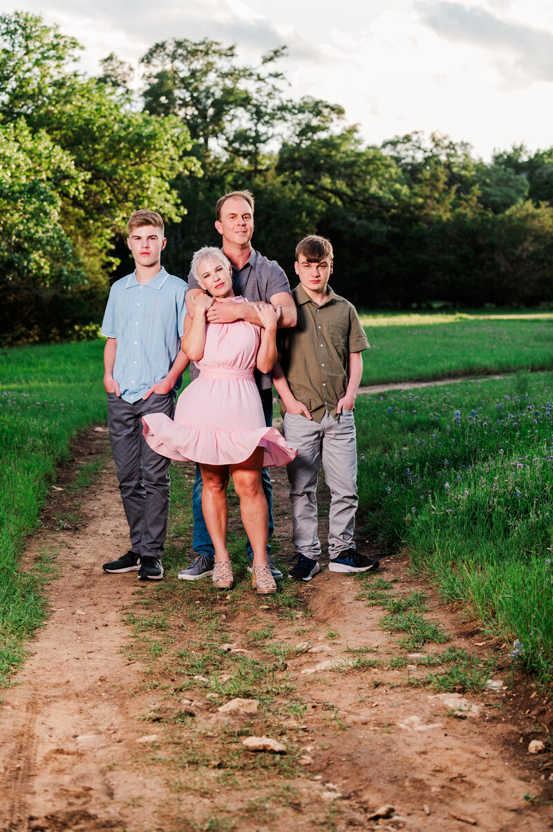 Serious Spring Portrait with a Family of 4. Taken in Dripping Springs Texas. Photo taken by Lydia Teague Photography.