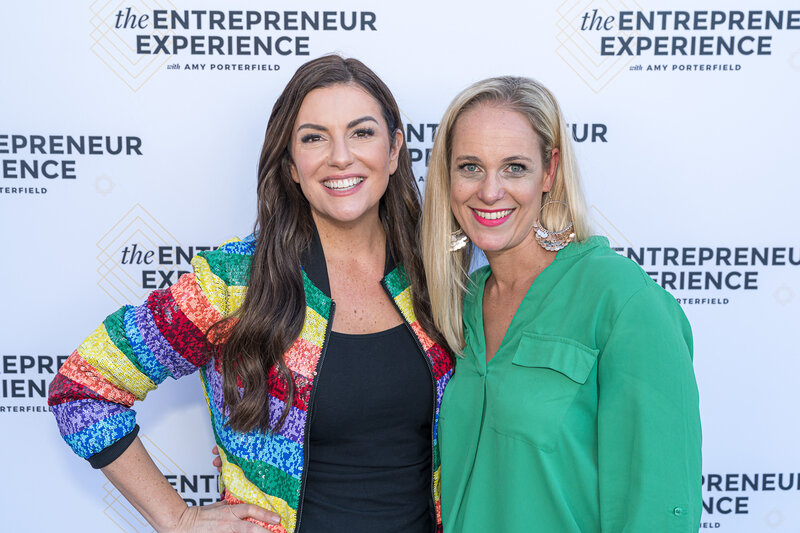 Amy Porterfield and Salome Schillack standing together and smiling at The Entrepreneur Experience event