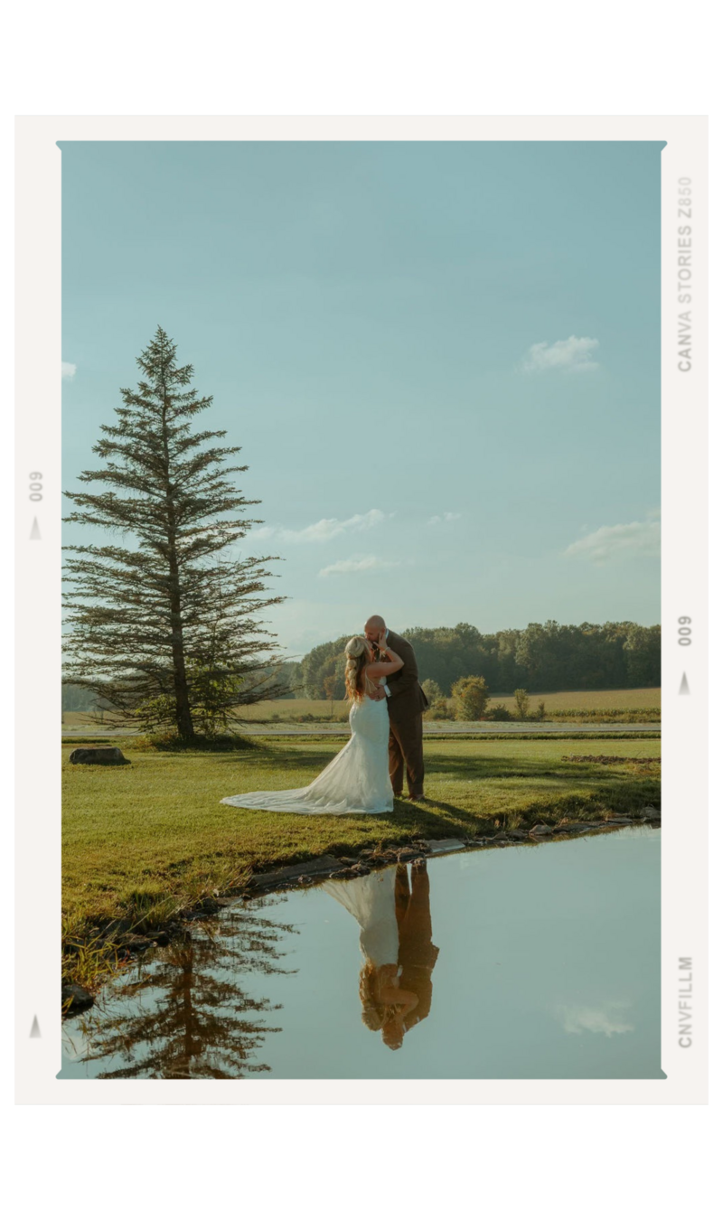 Couple kissing by a lake after their Ohio wedding