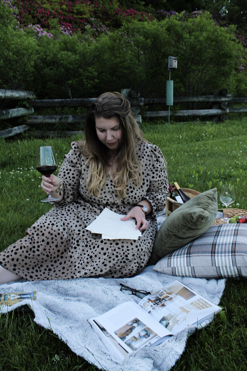Ashleigh Henry, identity coaching for women leaders, is staring out of a window on a winter's day in Asheville, North Carolina, considering her thoughts in a yellow and green room with old fashioneds by her side