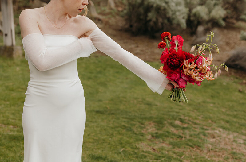 Spring wedding bouquet with protea, lilies, and garden roses