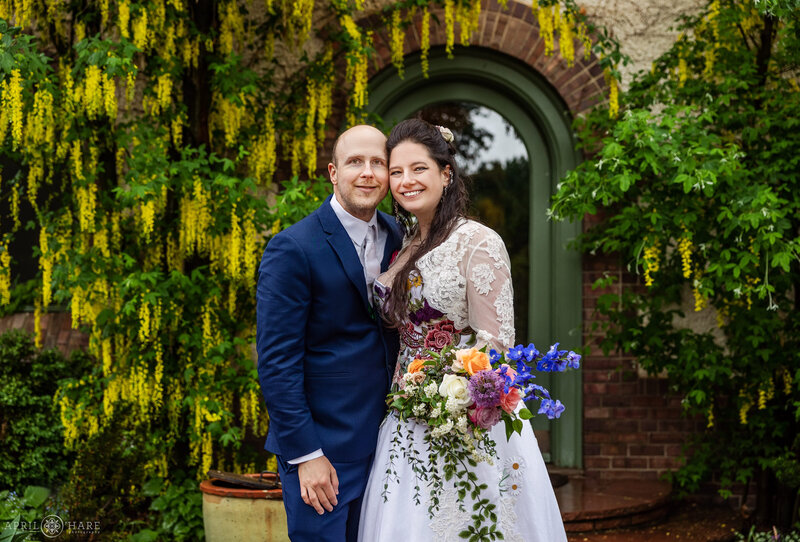 Beautiful wedding poto with arch green doorway of the Waring House in the Oval Garden at Denver Botanic Gardens