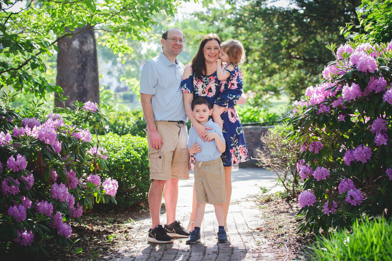 Photo of family smiling at an Essex County, New Jersey park in the spring.