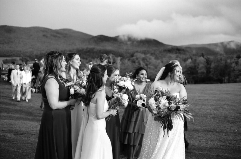 bride and bridesmaids celebrating after ceremony at mountain top inn in vermont