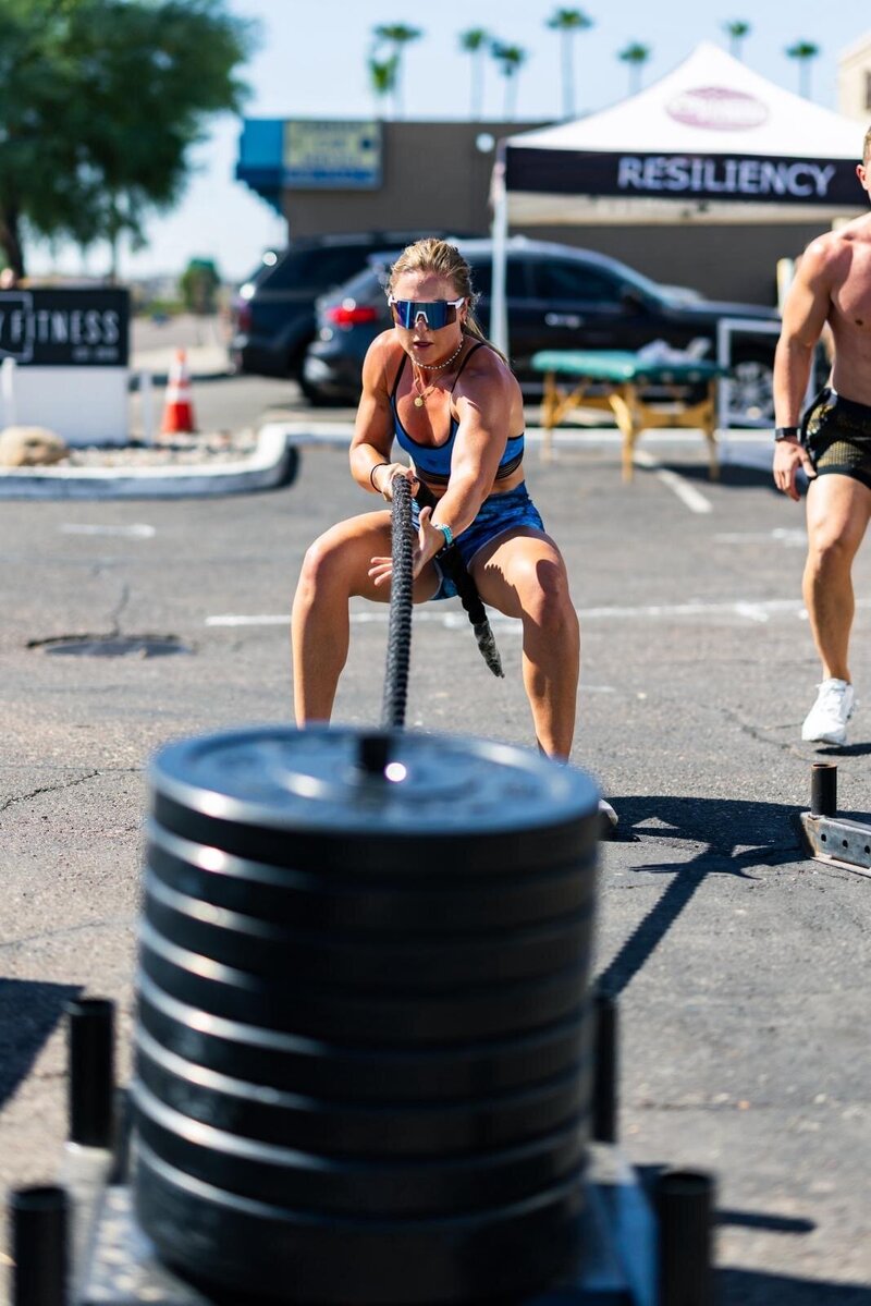 a female pulling weights in a competition