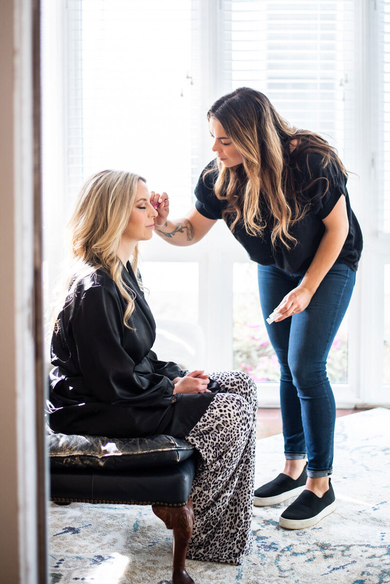 Applying Eyelashes on Client for photoshoot