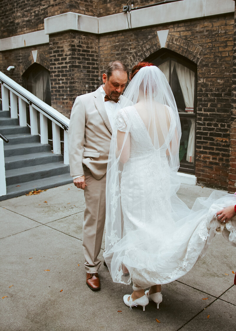 father crying with bride in white dress