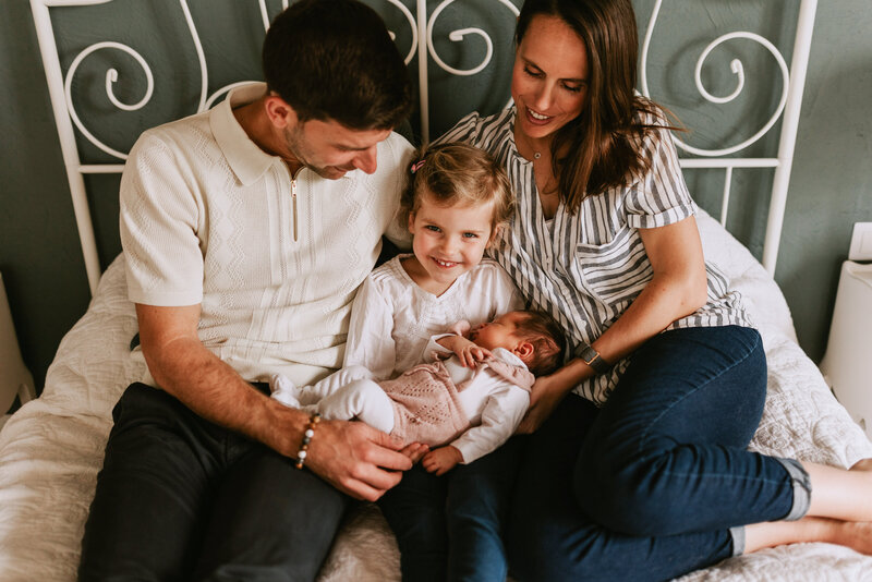 leslie-choucard-luxury-wedding-photographer-sitting-with-husband-adam-and-daughters