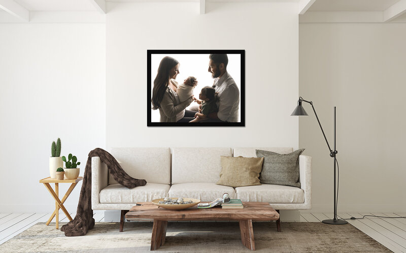 Newborn image framed in custom setting hanging on the wall