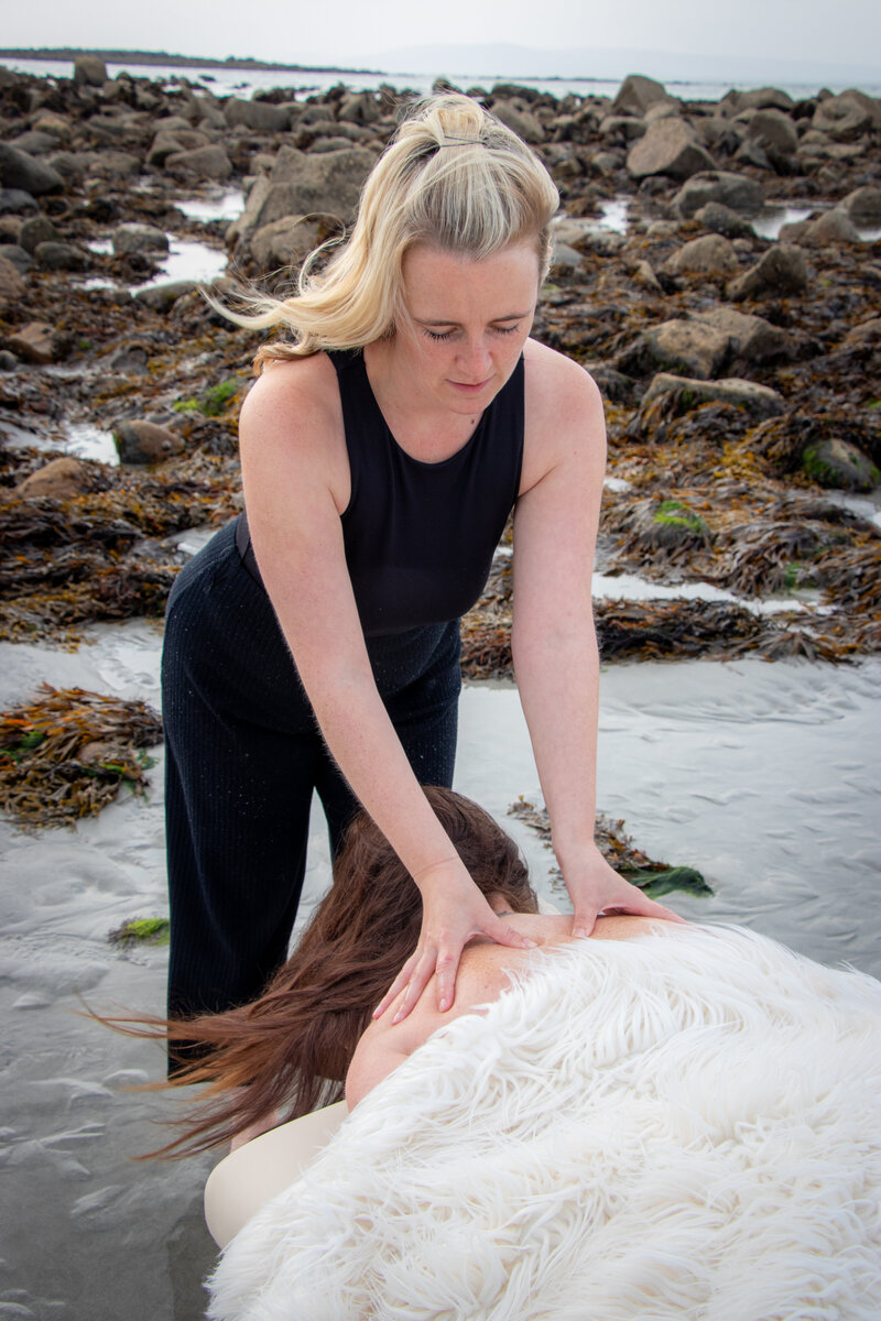 Massage therapist uses deep tissue techniques to alleviate tension in the back in galway