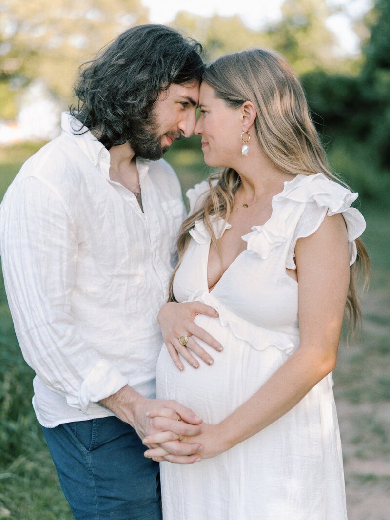 expecting-couple-happily-looking-at-each-other